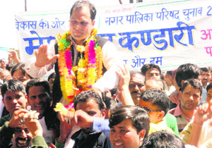 Congress rebel Megh Singh Kandari with his supporters at a rally in Mussoorie on Friday.