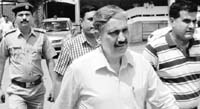 Sports Minister Sukhbir Kataria (centre) comes out of a Gurgaon court on Friday. A Tribune photograph