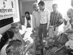 HRTC Vice-Chairman Kewal Singh Pathania listens to grievances of villagers at Manie village of Kangra subdivison on Friday. 