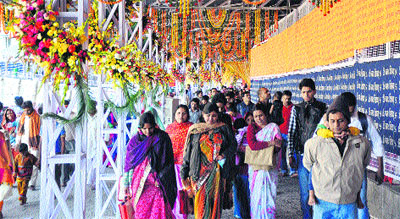 Devotees walk through elaborately decorated way to the Vaishno Devi shrine in Jammu on Friday. 