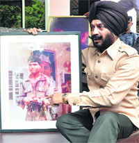MS Bitta with a photograph of the blast site outside Indian Youth Congress office in New Delhi on Friday. 