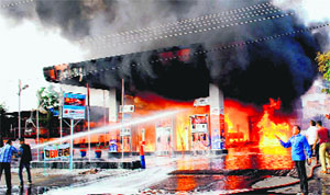 People try to douse the fire that broke out at a petrol station in Jodhpur on Friday.