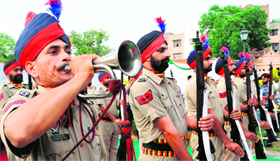 A contingent of the Punjab Police pays tributes to the martyrs by reversing arms in Amritsar on Saturday. 