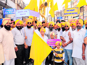 Members of the Akal Purakh Ki Fauj takes out a procession to mark Dastar Divas in Amritsar on Saturday.