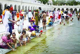 Sikh devotees have a holy bath at the Gurdwara Bangla Sahib during the Baisakhi festival in New Delhi on Saturday