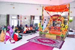 Devotees listen to shabad kirtan held on the occasion Baisakhi at Gol Gurdwara, Jwalapur, in Haridwar on Saturday. Tribune photo: Rameshwar Gaur