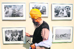 File photo of a Sikh viewing pictures of the 1984 riots at an exhibition.