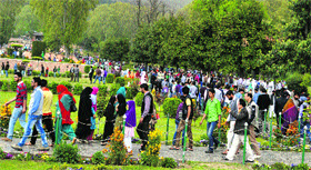 People throng Nishat Garden on Baisakhi in Srinagar on Saturday.
