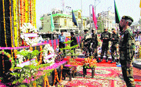 An Army officer pays homage to martyrs at Gujjar Chowk War Memorial in Rajouri on Saturday.