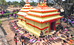Devotees lie on the ground during Danda festival at Mendhashala village of Khurda district, Orissa, on Saturday.