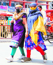  Girls cover their faces on a hot summer afternoon in Amritsar on Sunday.