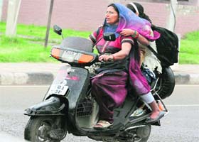 A woman and her daughter caught unawares by the rain at Sector 42, Chandigarh, on Sunday