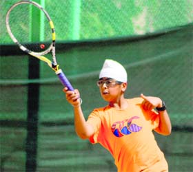 A player returns a shot during a lawn tennis match organised at Manav Mangal School, Sector 11, Panchkula, on Sunday