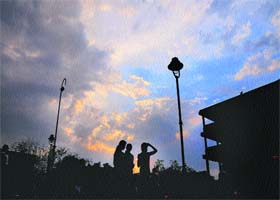 Residents enjoy the pleasant weather after light showers at the Sector 17 Plaza in Chandigarh on Sunday evening