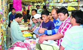 Students and their parents buy books for the new session from a bookstore at Sector 19 in Chandigarh
