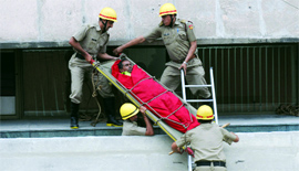 Firefighters rescuing a man from a high-rise.