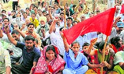Labourers raise slogans at Beant Singh Park in Jalandhar on Sunday to pay homage to the 23 labourers who were buried alive in Shital factory collapse a year ago
