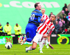 Manchester Uniteds Wayne Rooney is fouled by Stoke Citys Steven Nzonzi during their English Premier League match in Stoke-on-Trent on Sunday.