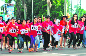 Indonesian participants run in the Fun with Your Heels event in Jakarta on Sunday.