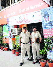 Policemen come out of the Bank of Baroda branch in Sector 17 on Monday. There was a false robbery alarm at the branch.