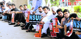 NSUI members sit in front of the Syndicate meeting hall of Panjab University on Monday.