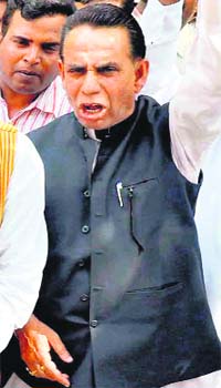 Naeem Qureshi raises slogans in favour of mayoral candidate Swami Rishiwaranand in Haridwar on Monday