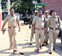 Policemen patrol Pabnawa village in Kaithal on Monday.
