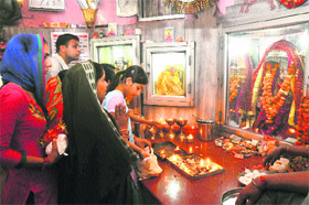 Devotees offer prayers during the ongoing Navratri festival at the Pracheen Mansa Devi Temple in Karnal. 