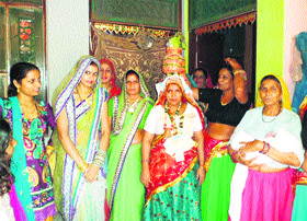 Lilawati, mother of the baby girl, along with other women performs the Kua Pujan ceremony at Bithwana village near Rewari. 