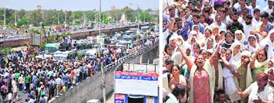 Traffic came to a standstill at Tawi Bridge as (below) relatives of a deceased PDD daily worker held a protest demanding action against officials responsible for his death in Jammu on Monday. tribune Photos: Inderjeet Singh