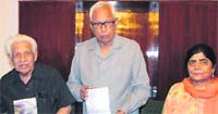 Governor NN Vohra releases a book Mere Hissey Ka Kashmir written by Kashmiri Lal Zakir at the Raj Bhawan in Jammu on Monday. A tribune photograph