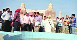 Government officials inspect the construction work of Wada Ghallughara Kup Rohira Memorial near Mandi Ahmedgarh on Monday. A Tribune photograph