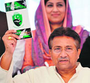 Former Pakistani President Pervez Musharraf holds a copy of his party manifesto at his residence in Islamabad on Monday.