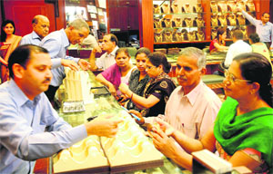 People buy gold at a shop in Secor 22, Chandigarh, on Tuesday. 