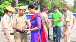Constables inspect a woman at the entry point of the PCA Stadium on Tuesday. 