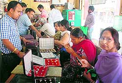 A jeweller in Sonepat does brisk business as the price of gold fell on Tuesday
