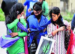 Girls walk through a storm in Shimla on Tuesday