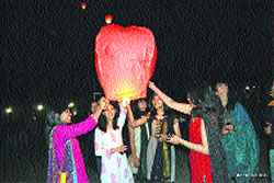 Students setting off a balloon lit with lanterns during the NIMBUS-2013 at NIT in Hamirpur.