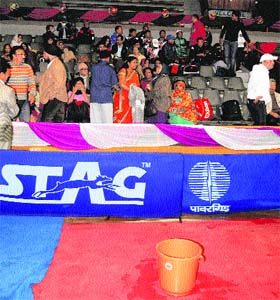 A bucket was kept to collect raindrops falling from the rooftop of the Indoor Stadium at the inaugural function of the J&K Bank National Table Tennis meet in Srinagar on Tuesday