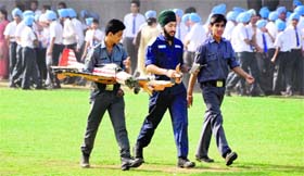 NCC cadets with a damaged toy plane during an airshow at Guru Nanak Public School in Ludhiana on Tuesday