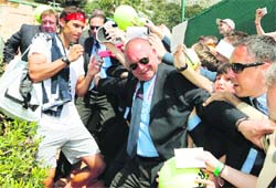 A security official tries to keep Rafael Nadal safe in Monte Carlo on Tuesday.  AFP
