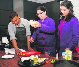 Chef Anubhav (centre) prepares a dish