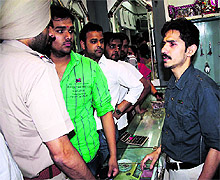 The jeweller, who was robbed by two youths, gives his statement to policemen in Amritsar on Wednesday evening