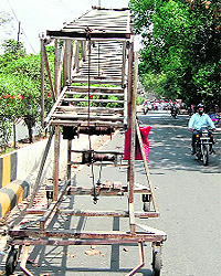 A trolley to repair street-lights parked haphazardly on the busy Mall Road in Amritsar on Wednesday