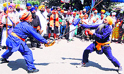 Sikh youths perfom gatka on the eve of the 392nd birth anniversary of Guru Teg Bahadur in Amritsar on Wednesday