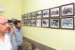 Visitors admire the pictures on display at Bathinda railway station. Tribune photo: Pawan Sharma