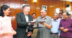 Chief Minister Vijay Bahuguna exchanges MoU papers with Coca-Cola vice-president Patrick George in Dehradun on Wednesday. 