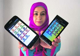 Mehvish Mushtaq displays applications on mobile phones, which she developed on Kashmir, in Srinagar on Wednesday