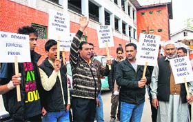 Seeking justice: People raise slogans during a protest against fake drugs scandal in Srinagar on Thursday