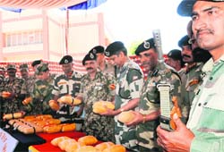 BSF officials show the contraband seized from the Khemkaran Sector on Wednesday. Photo: Vishal Kumar
